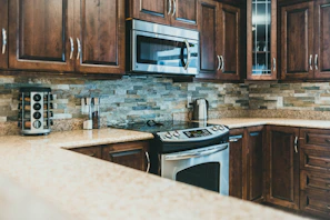Modern kitchen with full equipment and subtle Andean patterned backsplash