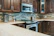 Installation process of PU stone panels on a kitchen backsplash.