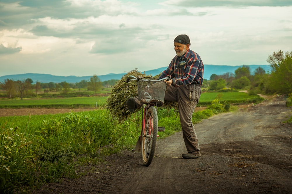 man in red blue and white plaid dress shirt and brown pants riding bicycle during daytime