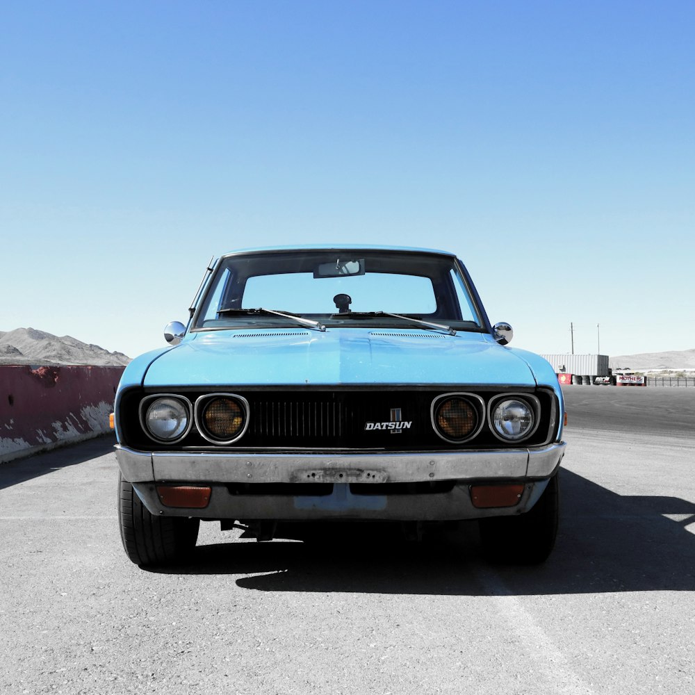 blue chevrolet camaro on road during daytime