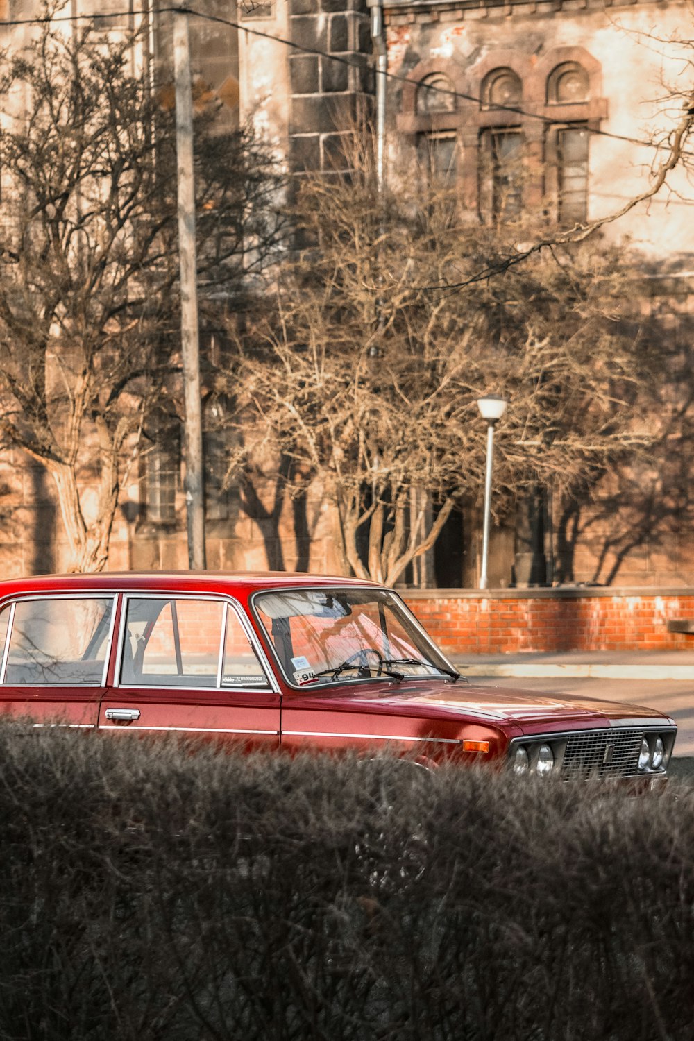 red and black car on road during daytime