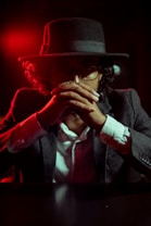 man in black suit jacket wearing red hat