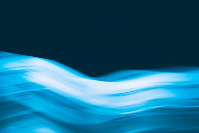 Abstract blue gradient waves symbolizing light and sound energy flowing smoothly.
