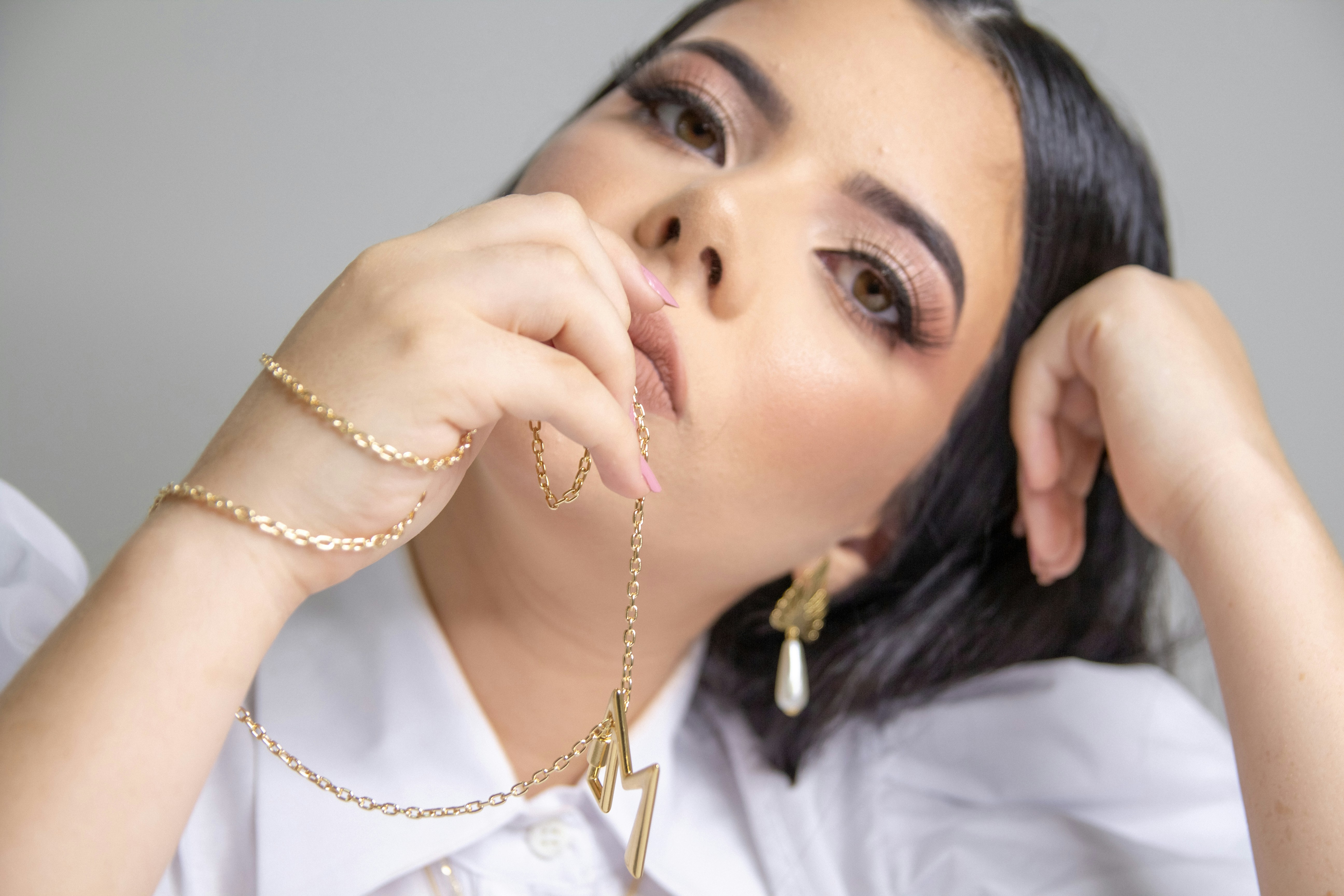 Stylish woman wearing layered dainty jewelry