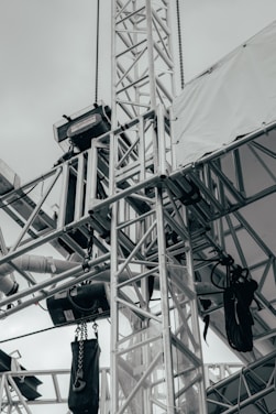 A modern metal truss structure in a construction setting.
