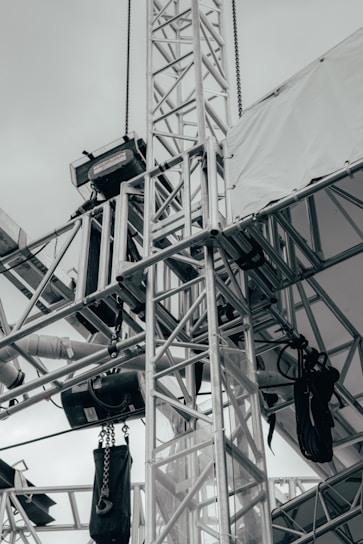 A modern metal truss structure in a construction setting.