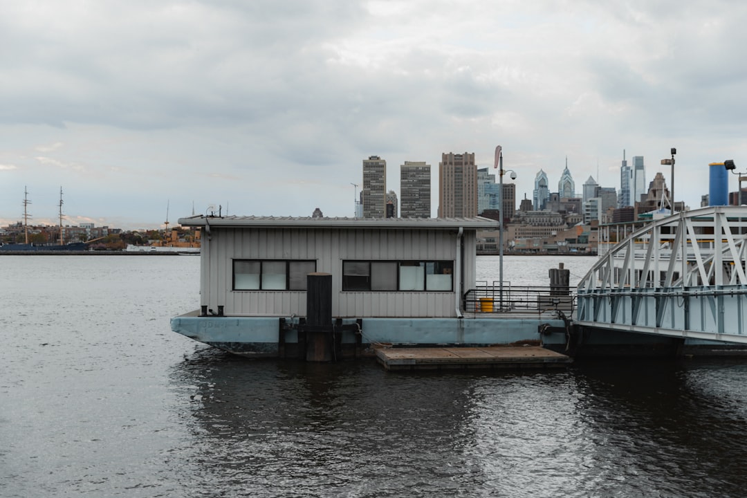 white and black boat on water near city buildings during daytime