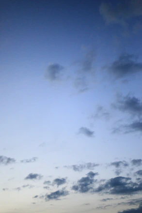 A serene sky blue gradient background with subtle clouds symbolizing clarity and growth.