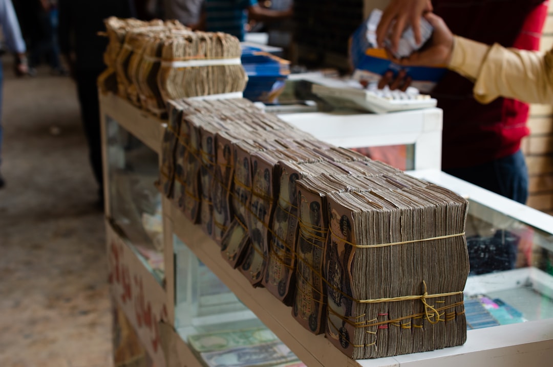brown wooden frame on white table, Iraqi dinars sit out at a currency exchange in the Kurdistan Region of Iraq.