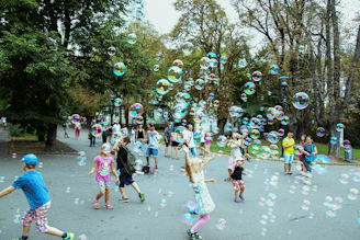A vibrant scene of children joyfully playing with colorful foam water balls in a sunny backyard.