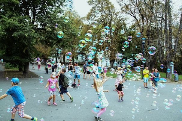 A cheerful scene featuring children playing with bunbuntoys in a sunny park
