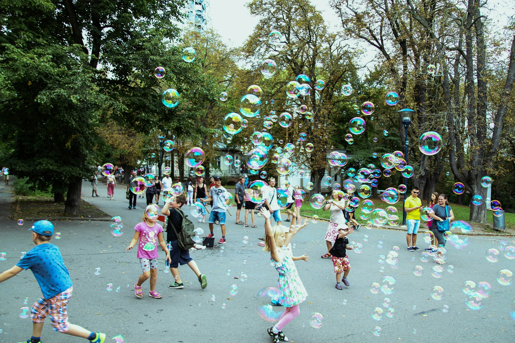 Snapshot of children playing with bubbles on the streets of Prague in Europe