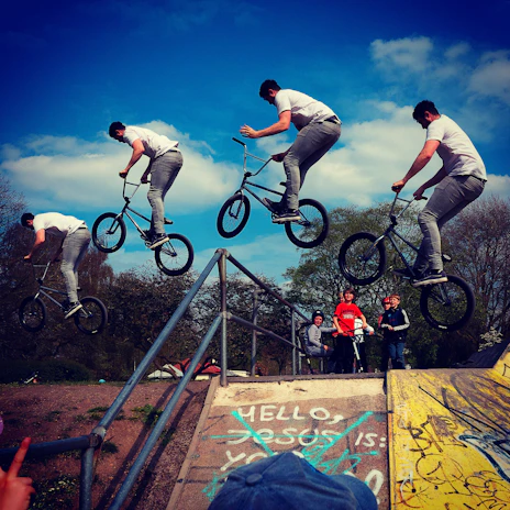 Riders doing a synchronized jump during an urban BMX event organized by Ruckstars.