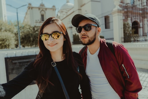 man in black crew neck shirt beside woman in red cardigan