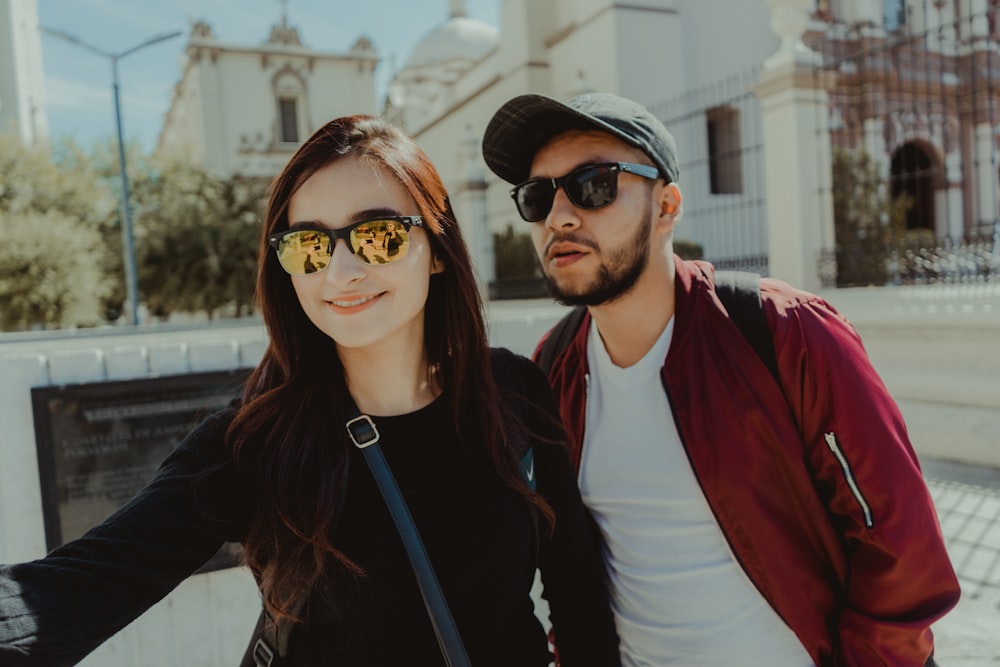 man in black crew neck shirt beside woman in red cardigan