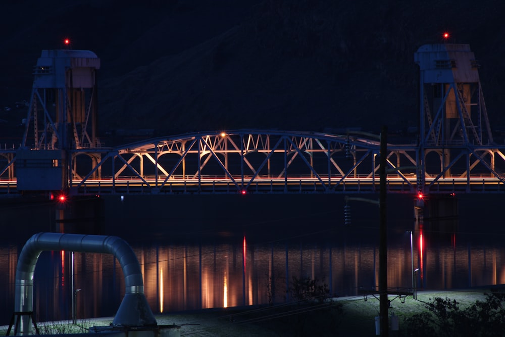 blue metal bridge during night time