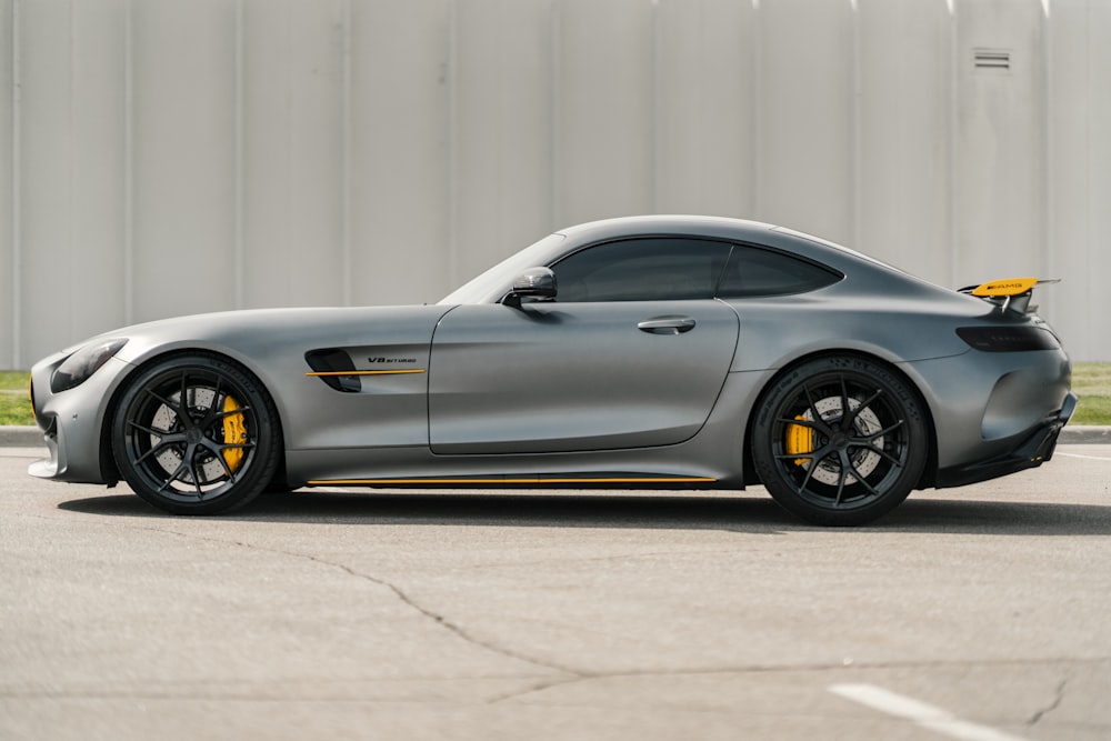 gray coupe parked on gray concrete pavement