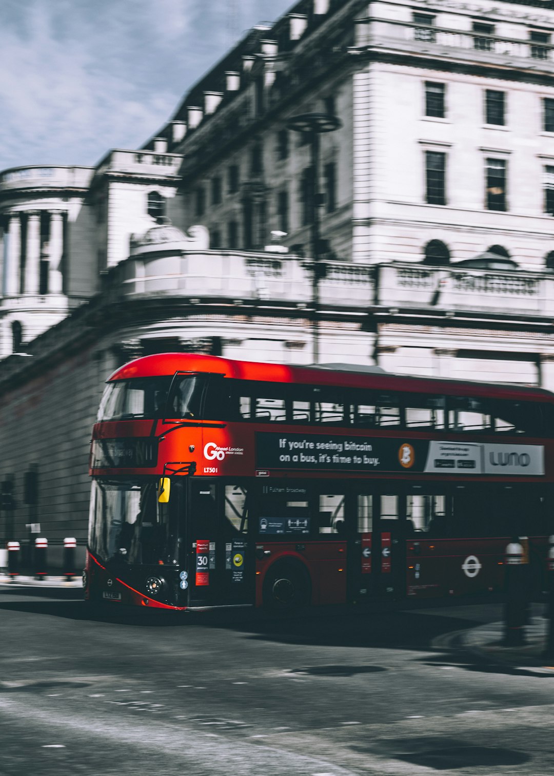 red double decker bus on road near building during daytime