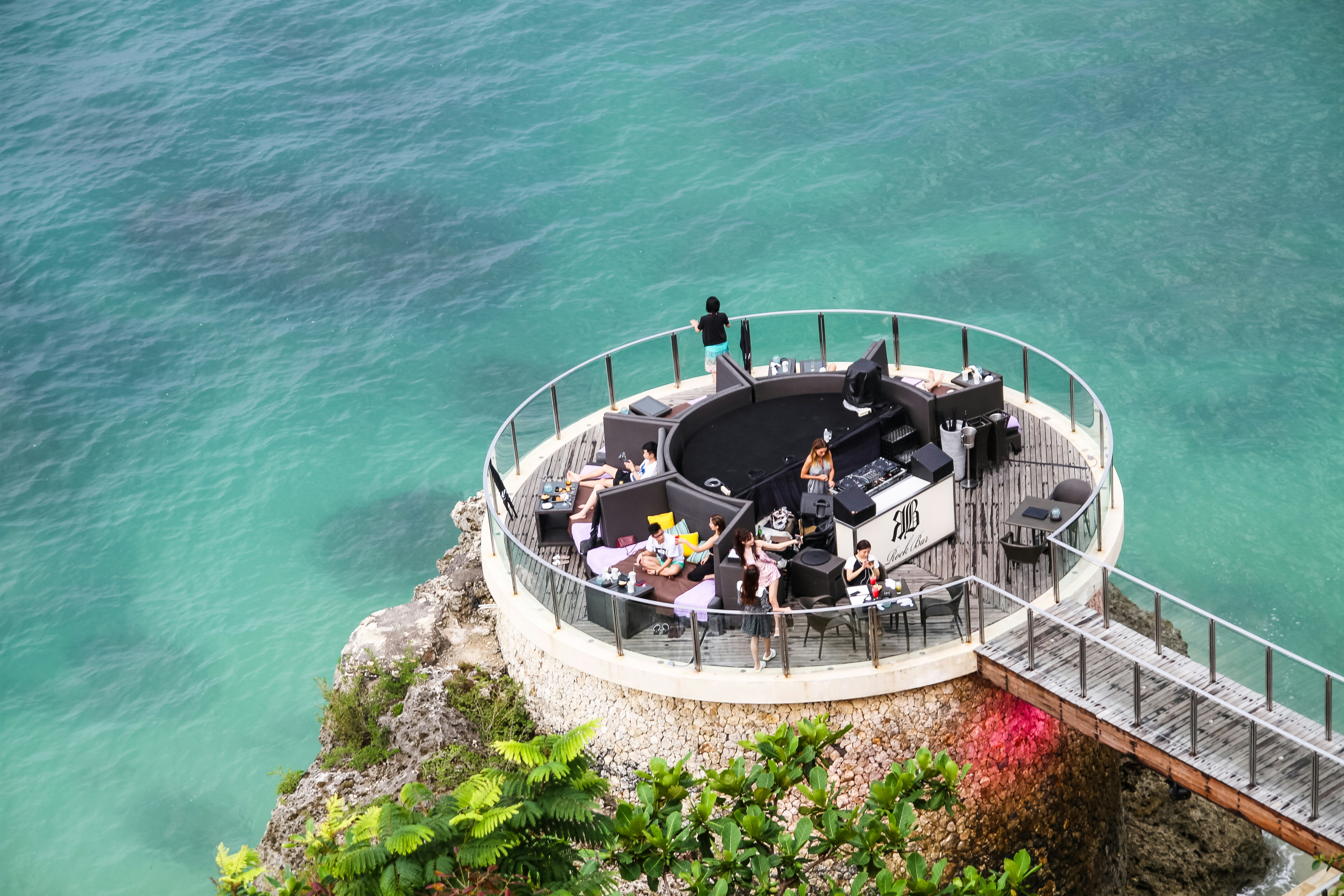 people on white and gray building near sea during daytime