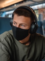 man in grey crew neck shirt wearing black headphones