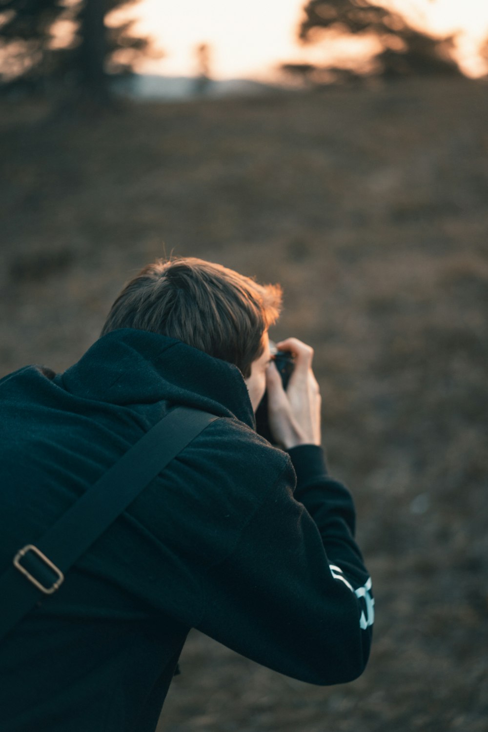 person in black jacket holding smartphone