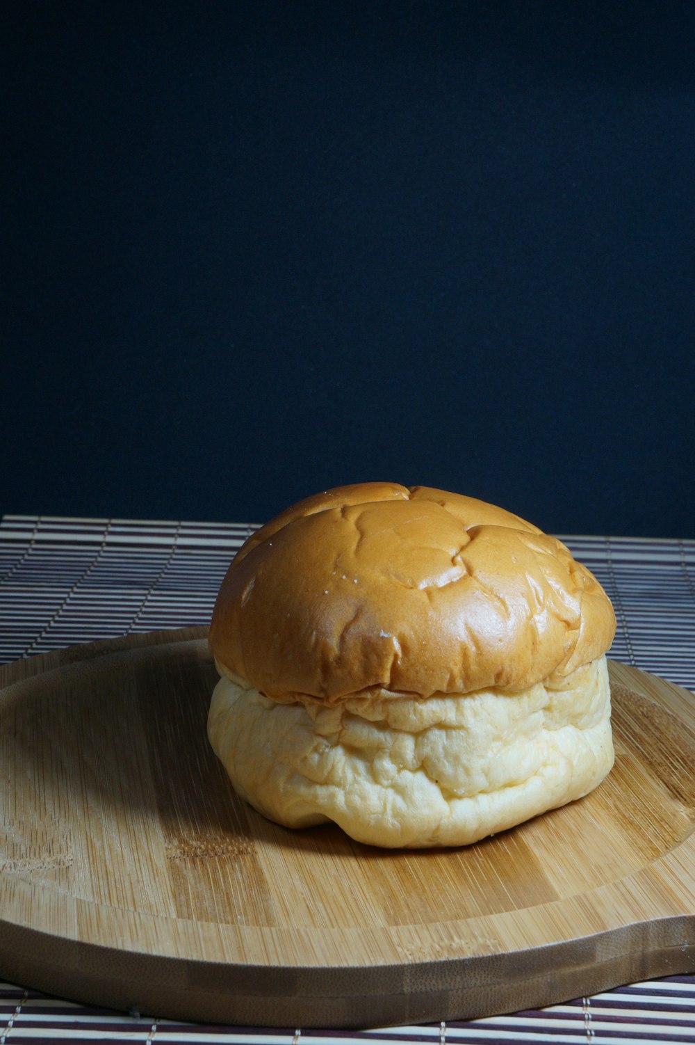 burger on brown wooden chopping board