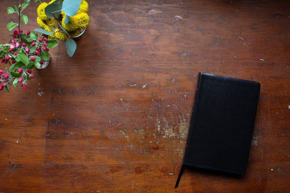 black book on brown wooden table