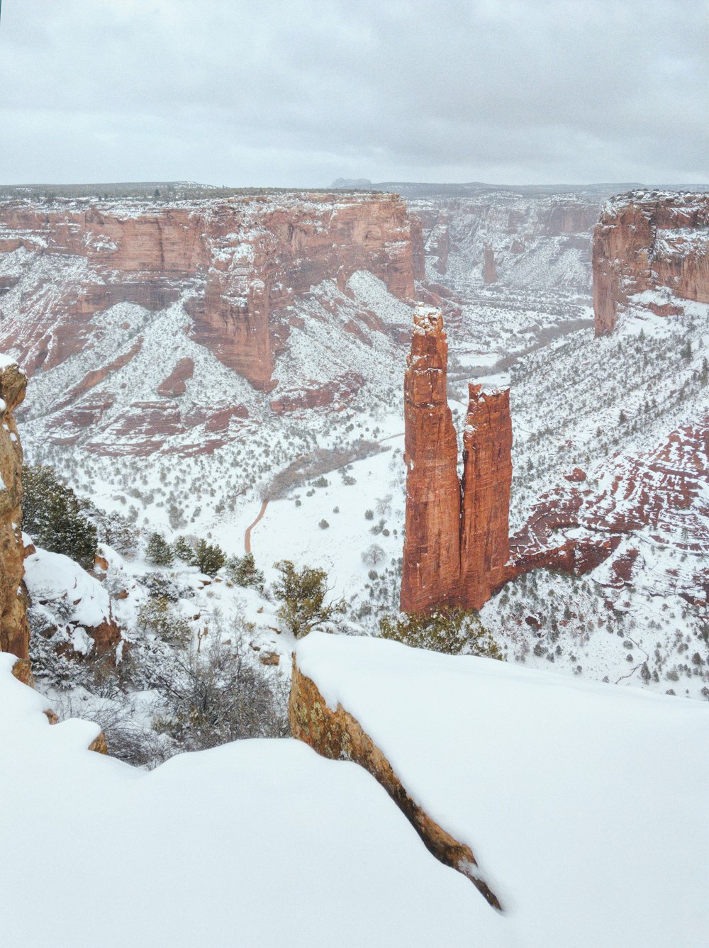 brown rocky mountain covered with snow during daytime