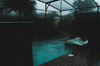Inviting jacuzzi pool glowing softly under ambient spa lighting.