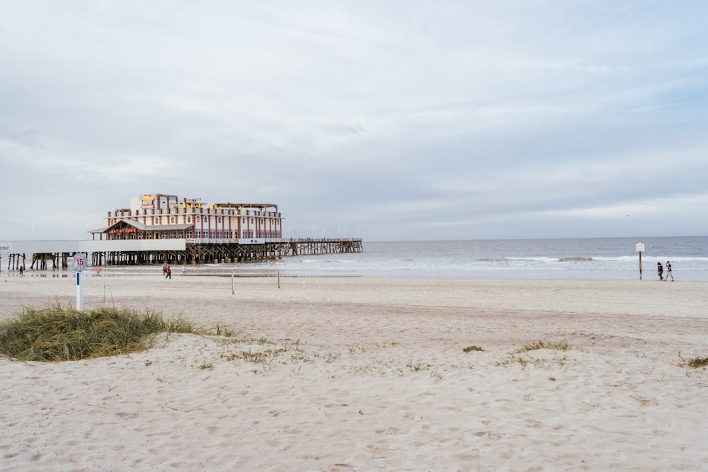 brown wooden dock on beach during daytime