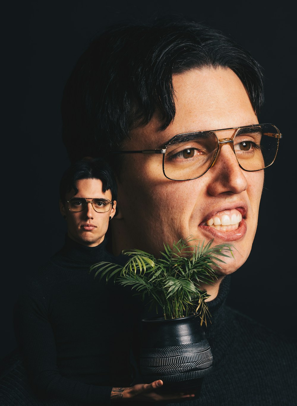 man in black framed eyeglasses smiling