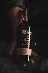 Close-up of a luxury rum bottle with golden hues and embossed label.