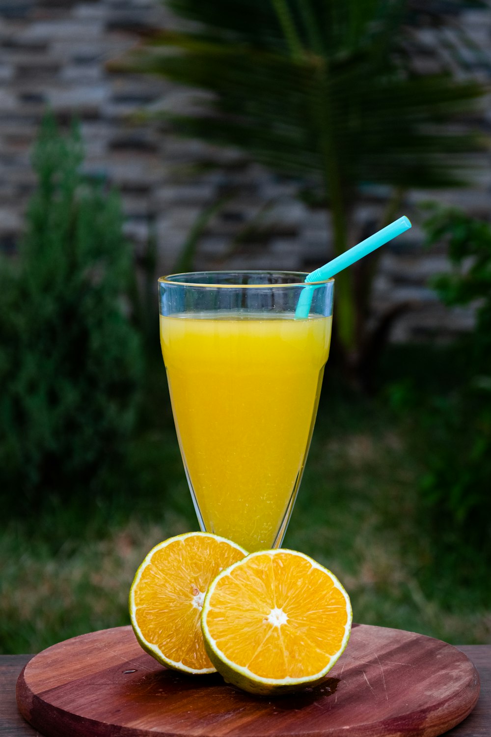 clear drinking glass with yellow liquid and orange slice