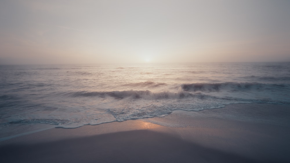 ocean waves crashing on shore during daytime