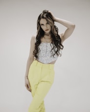 woman in white tank top and yellow pants