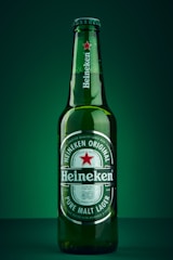 heineken beer bottle on green surface