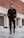 man in black suit jacket and black pants standing on gray concrete floor during daytime