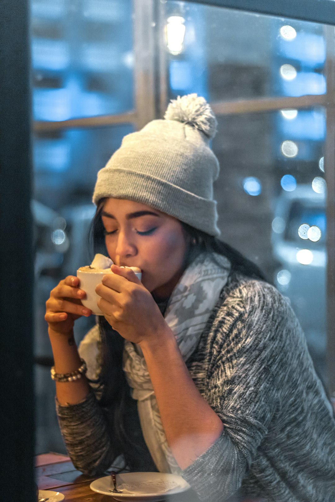 woman in white knit cap and gray and black long sleeve shirt