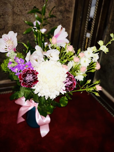 A vibrant bouquet of assorted flowers in a glass vase.