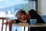 woman in black long sleeve shirt lying on white wooden table