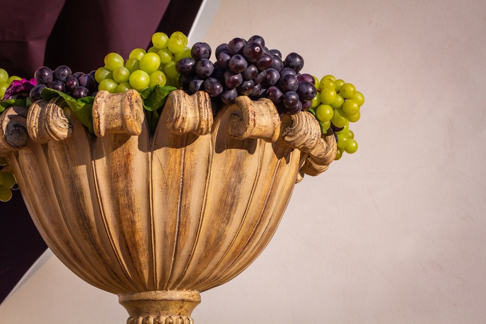 green grapes on brown wooden round container