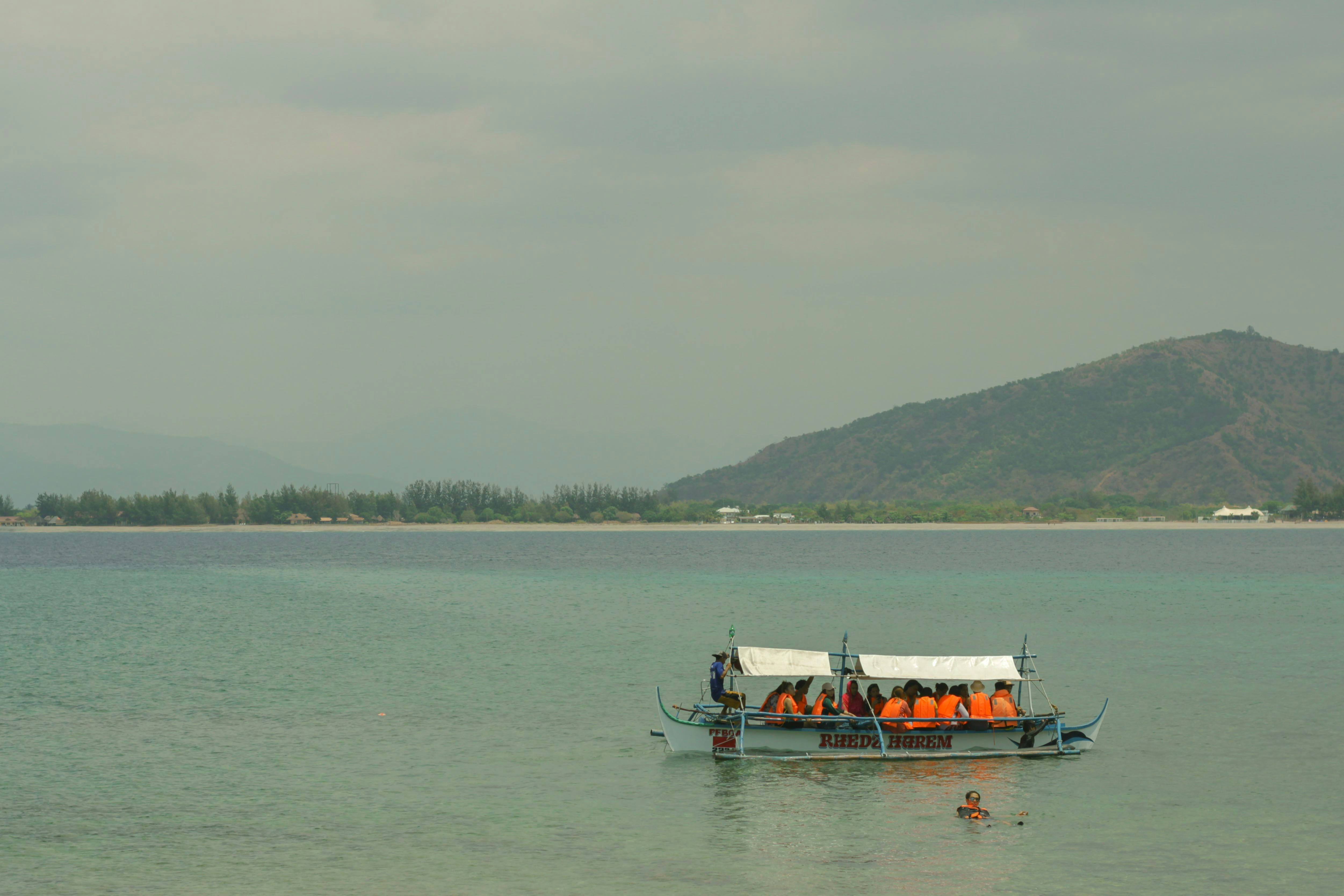 people riding on boat on sea during daytime
