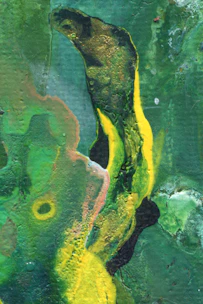 A vibrant abstract splash of light green mixed with orange and yellow hues.