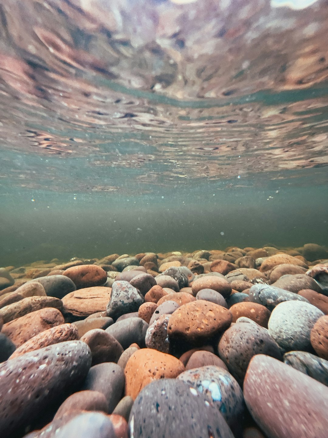 brown and gray stones near body of water