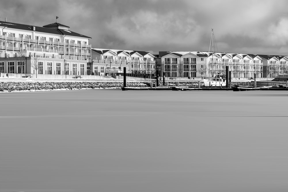 grayscale photo of building near body of water