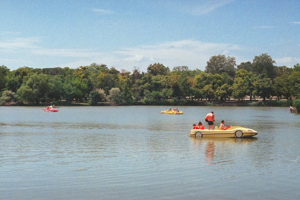 people riding yellow and red kayak on body of water during daytime