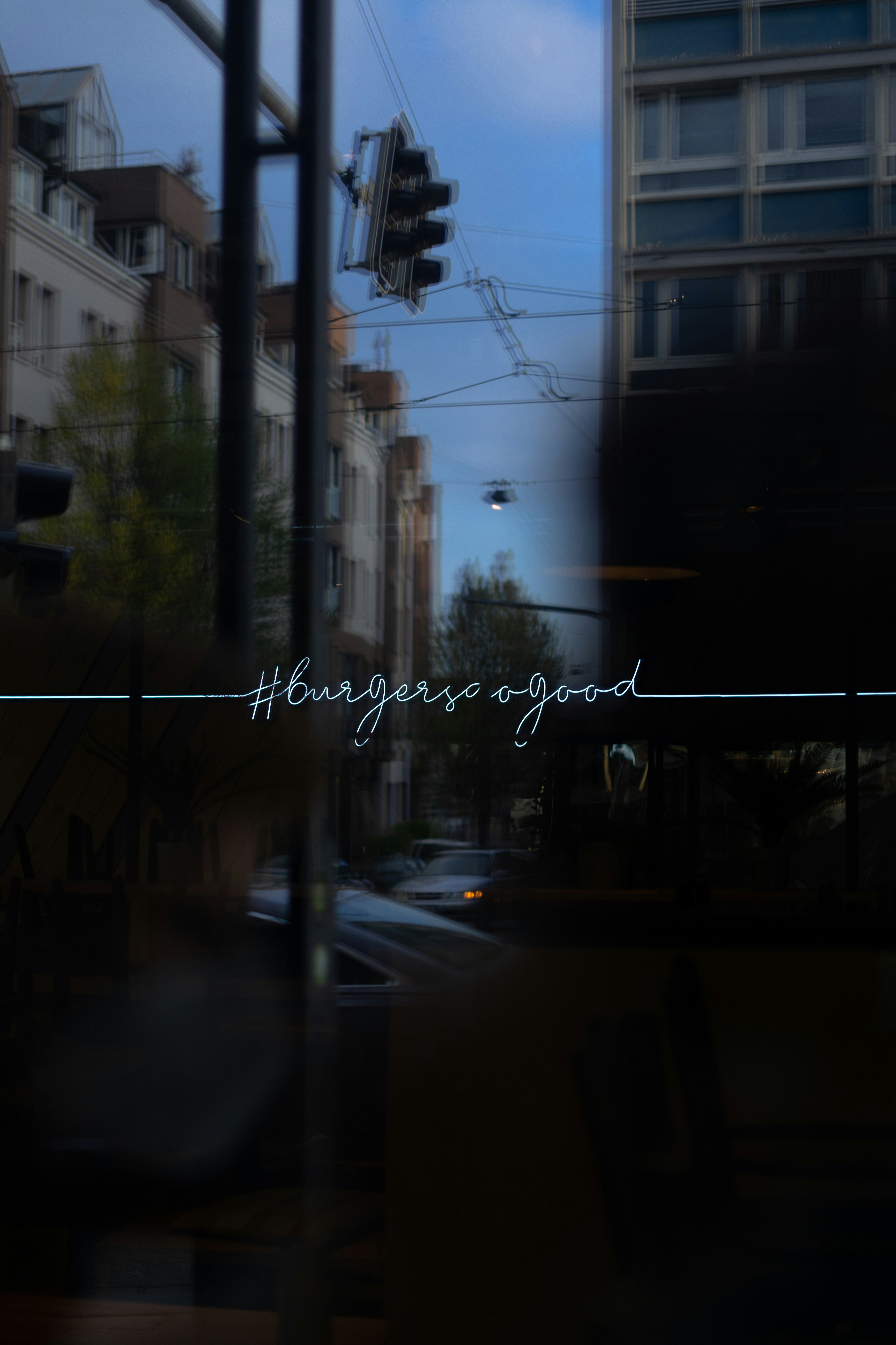 Neon city skyline reflected in glass windows for indie discoveries playlist