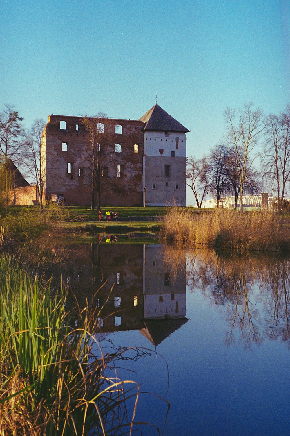 brown brick building beside river during daytime