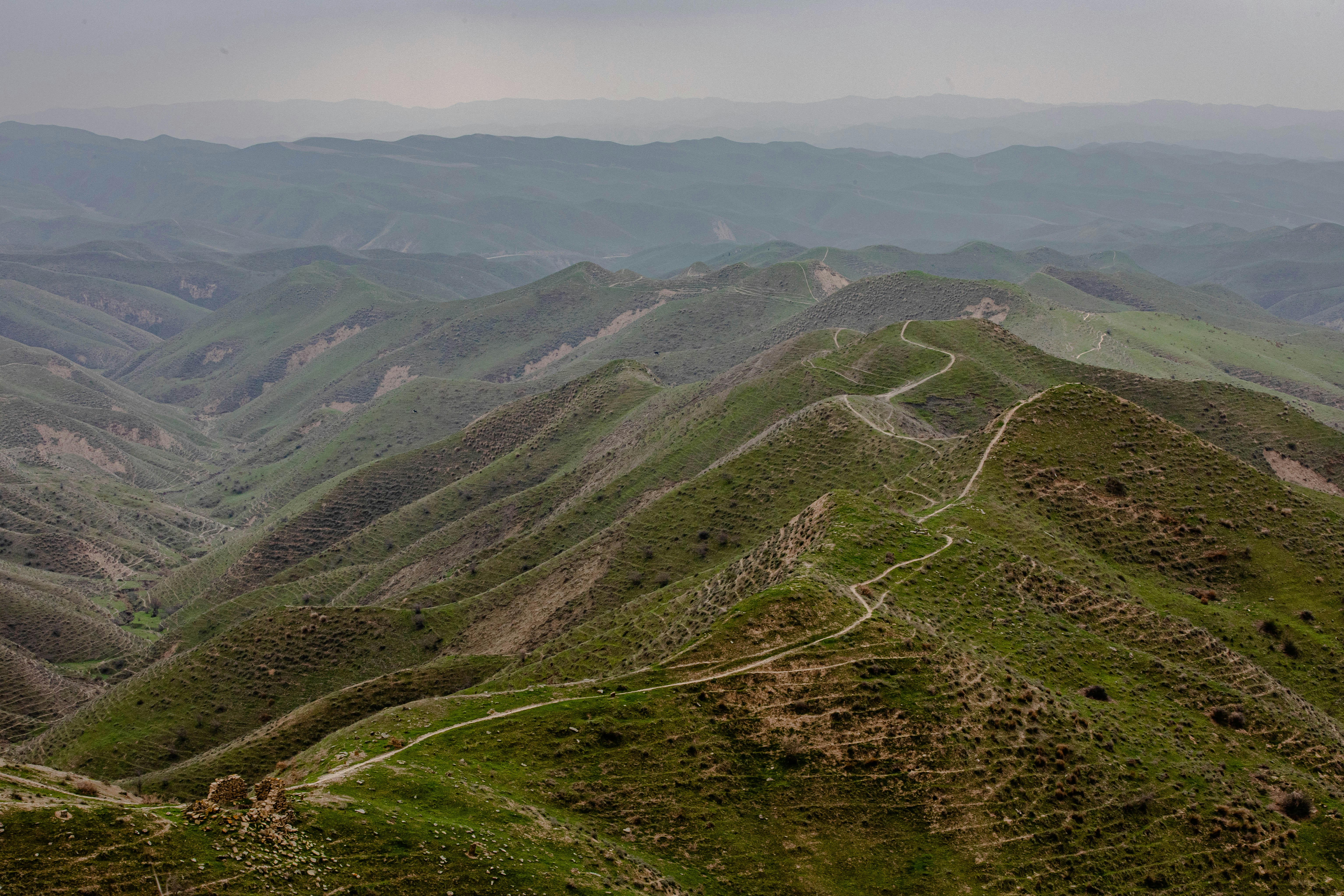 green grass covered mountain during daytime
