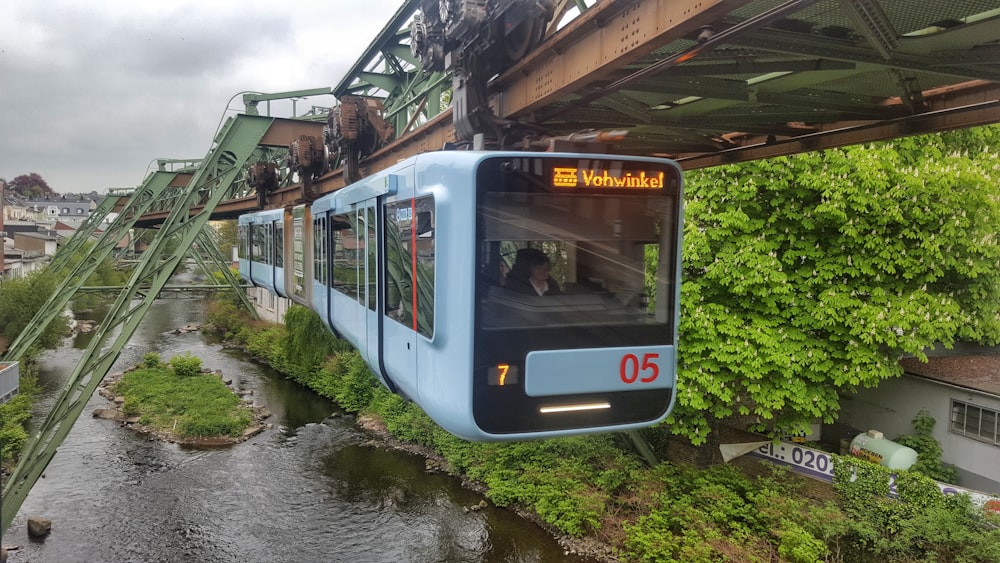 white and blue train on rail tracks